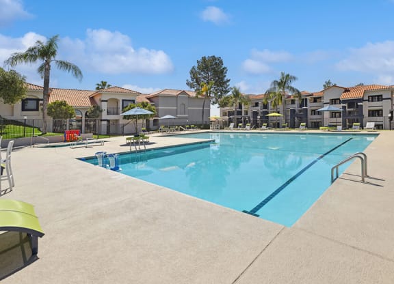 Community Swimming Pool with Pool Furniture at Hilands Apartments in Tucson, AZ.