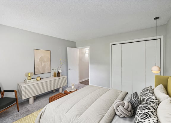Model Bedroom with Carpet and Closet at Indigo Park Apartments located in Albuquerque, NM.