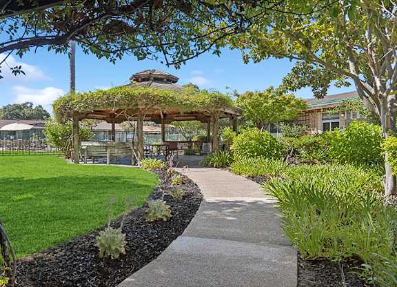 Gazebo with plants on top and a sidewalk at Walnut Creek Manor Apartments in Walnut Creek, CA