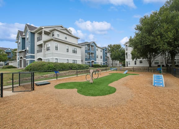 Community Dog Park with Agility Equipment at Hidden Creek Apartments located in Lewisville, TX.