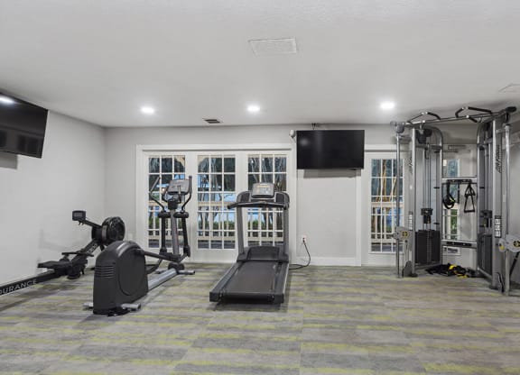 Community Fitness Center with Equipment at Walden Lake Apartments in Plant City, FL.