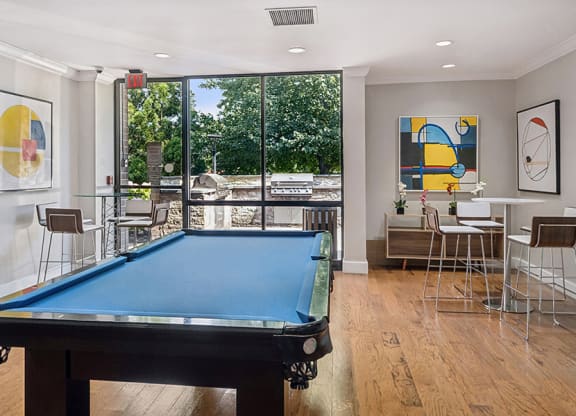 Community Clubhouse with Game Tables and Lounge Furniture at Mason Van Dorn Apartments located in Alexandria, VA.