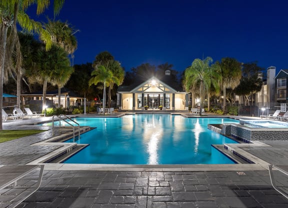 Community Swimming Pool with Pool Furniture at Caribbean Breeze Apartments in Tampa, FL.