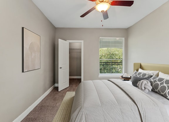 Model Bedroom with Carpet and Walk In Closet at Park West Apartments located in Houston, TX.