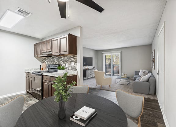 Model Dining Room and Kitchen Area with Wood-Style Flooring at Paramont Apartments in Duluth, GA.