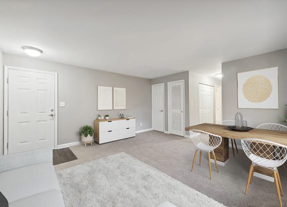 Model Living Room with Carpet and View of Dining Room at Spring Forest Apartments in Raleigh, NC.