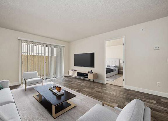 Model Living Room with Wood-Style Flooring and Patio Accessibility at Butler Ridge Apartments located in Glendale, AZ.