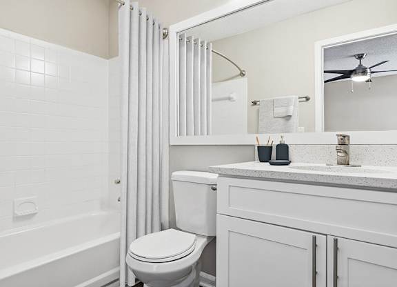 Model Bathroom with White Cabinets, Wood-Style Flooring and Shower/Tub at Element 41 Apartments located in Marietta, GA.