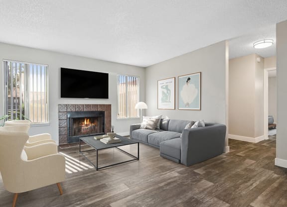 Model Living Room with Wood-Style Flooring and Fireplace at Peaks on 4th Apartments in Avondale, AZ.