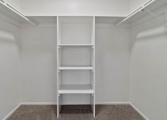 Model Closet with Carpet and Built In Shelves at Fullerton Hills Apartments located in Fullerton, CA.