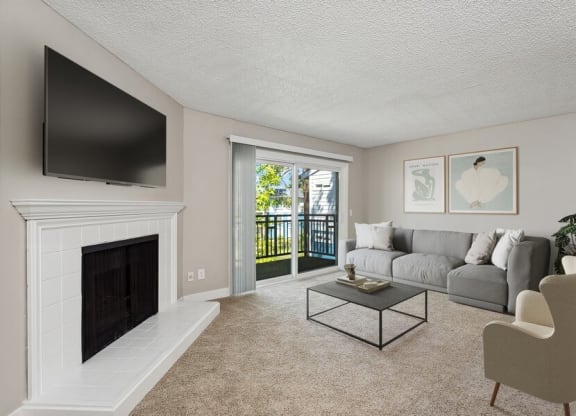 Model living room with a fireplace and a sliding glass door