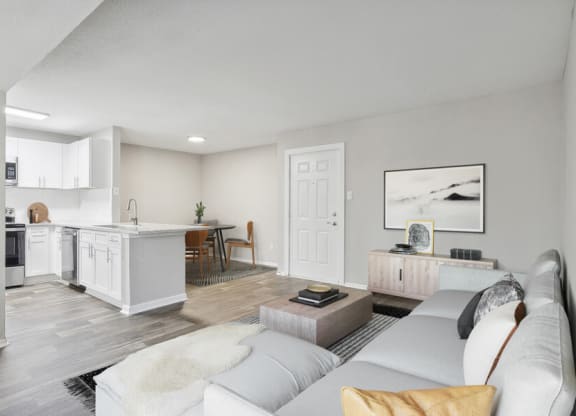 a living room with a couch and a kitchen