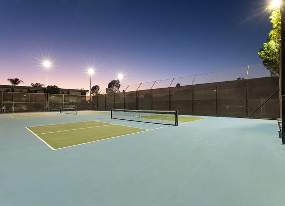 Community Tennis Court with Nets at Madison Park Apartments located in Anaheim, CA.