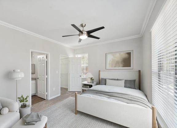 Model Bedroom with Carpet and attached Bathroom at Chapel Hill Apartments in Lewisville, TX.