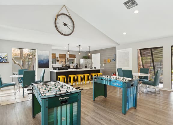 Community Clubhouse with Kitchenette and Game Tables at Grand Pavilion Apartments in Tampa, FL.