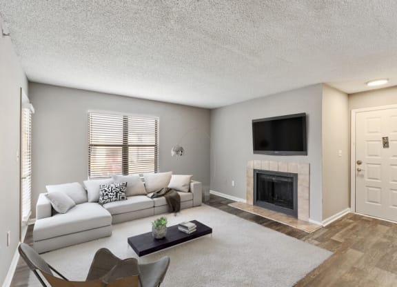Model living room showcasing large area and fireplace