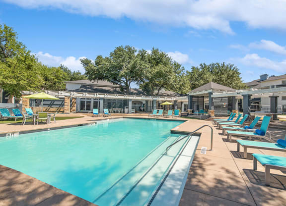 Community Swimming Pool with Pool Furniture at Allure North Dallas Apartments in Dallas, TX.