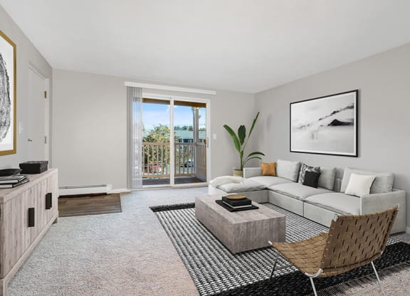 Model Living Room with Carpet and Patio Accessibility at Stone Ends Apartments in Stoughton, MA.