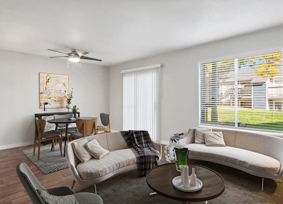 Model Living Room with Wood-Style Flooring and Patio Accessibility at Overlook Point Apartments in Salt Lake City, UT.