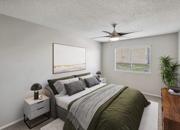 Model Bedroom with Carpet and Window View at Solano Springs Apartments located in Tucson, AZ.