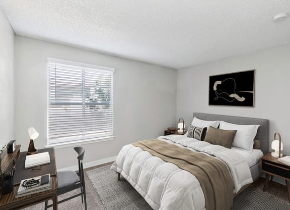 Model Bedroom with Carpet and Window View at Indigo Park Apartments located in Albuquerque, NM.