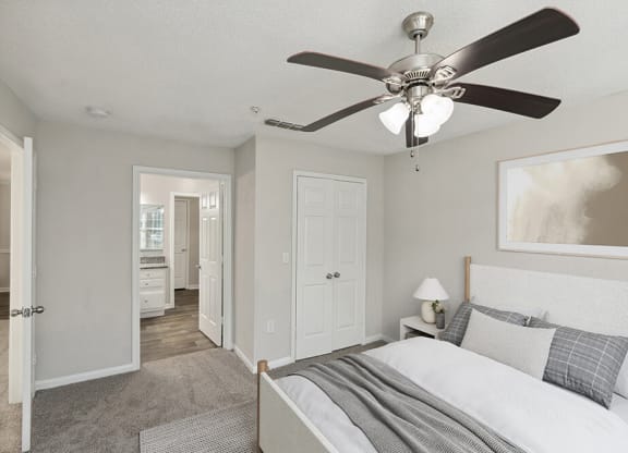 Model Bedroom with Carpet and attached Bathroom at Shadow Ridge Apartments in Riverdale, GA.