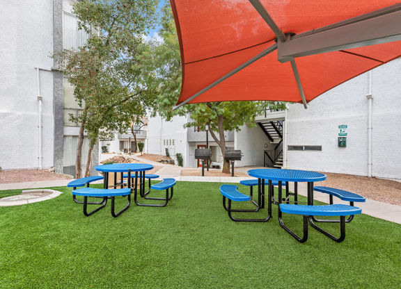 Outdoor Pic Nic Area with Tables and Orange Canopy at Crystal Creek Apartments in Phoenix, AZ.