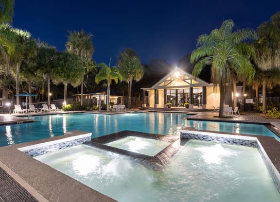 Community Swimming Pool with Pool Furniture at Caribbean Breeze Apartments in Tampa, FL.
