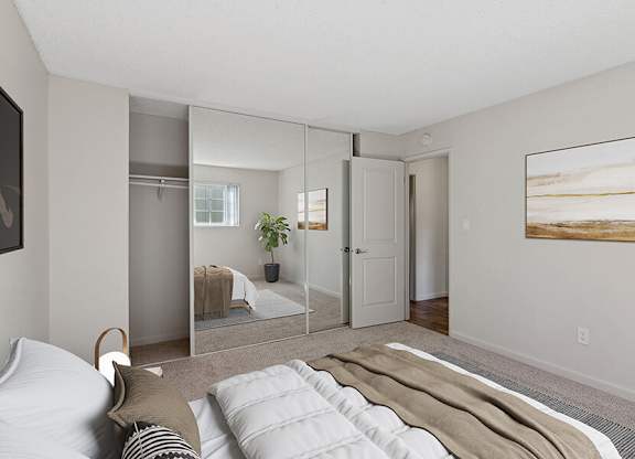 Model Bedroom with Carpet and Large Closet at Los Gatos Landing Apartments located in San Jose, CA.