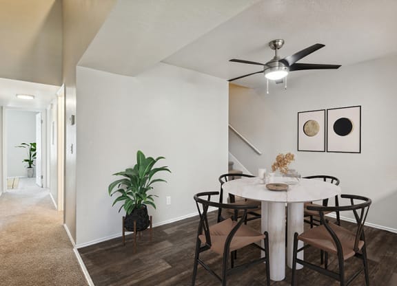 Model Dining Room with Wood-Style Flooring & View of Hallway at Broadmoor Village Apartments in Salt Lake City, UT.