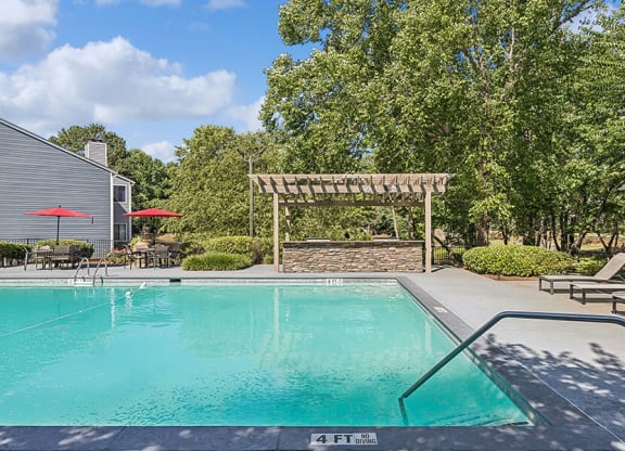 Community Swimming Pool with Pool Furniture at Lakeside Retreat Apartments located in Peachtree Corners, GA.