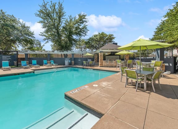 Community Swimming Pool with Pool Furniture at Allure North Dallas Apartments in Dallas, TX.