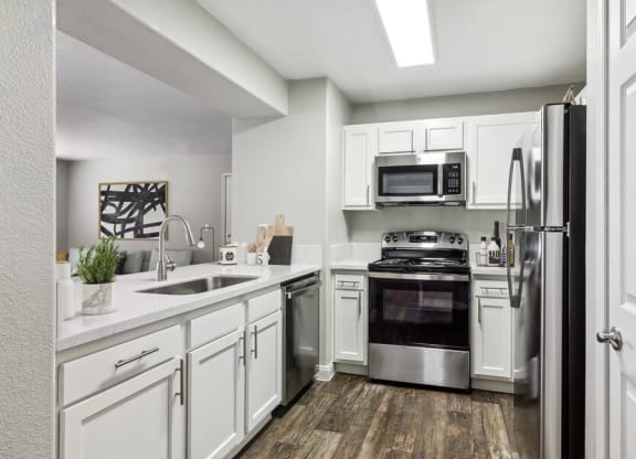 Model kitchen with white cabinets and stainless steel appliances