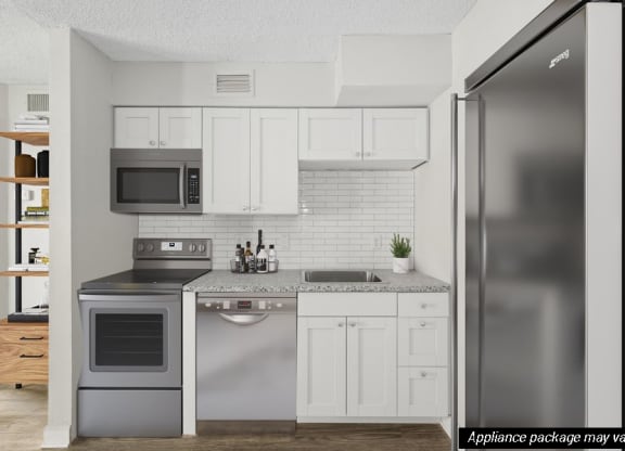 Model kitchen with white cabinetry