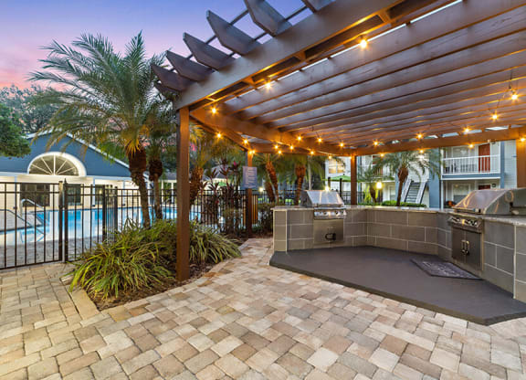 Outdoor BBQ Area with Canopy at Retreat at Crosstown Apartments in Riverview, FL.
