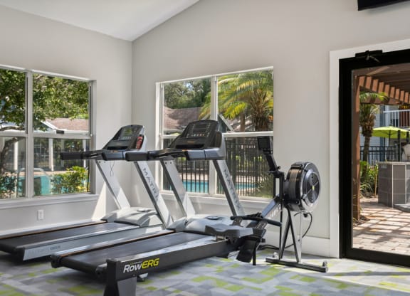 Fitness center with treadmills at Retreat at Crosstown Apartments