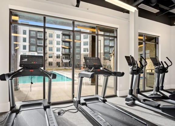 treadmills with view of pool in gym