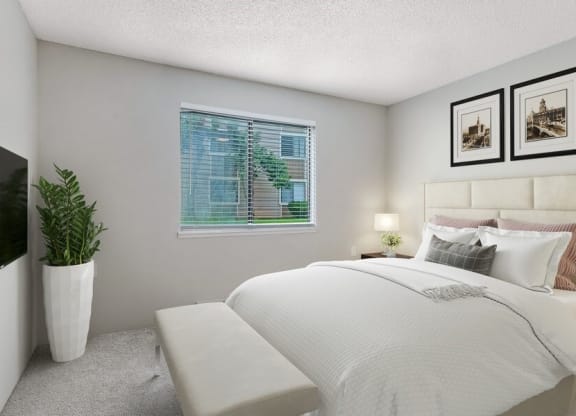 Model bedroom with carpeting with queen-size bed