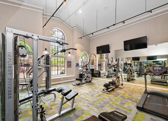 Community Fitness Center with Equipment at Dallas North Park Apartments in Dallas, TX.