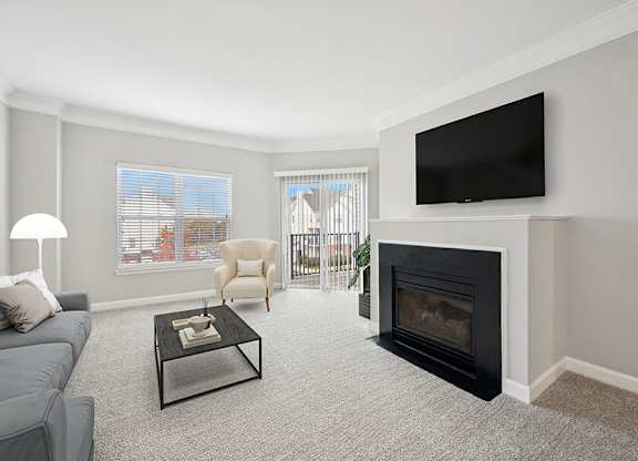 Model Living Room with Carpet and Fireplace at Dulles Green Apartments located in Herndon, VA.