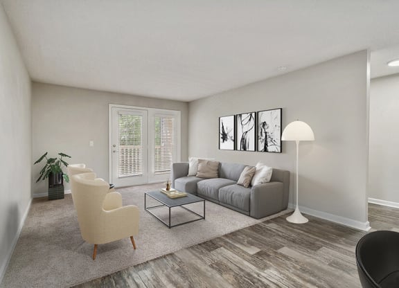 Model Living Room with Carpet and Patio Accessibility at Retreat at Stonecrest Apartments located in Lithonia, GA.