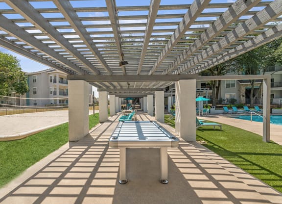 Outdoor Ping Pong Table and Pool Area at Essence Apartments in Dallas, TX.
