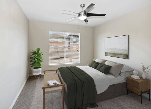 Model Bedroom with Carpet and Window View at Belmont at Belmont at Duck Creek Apartments in Garland, TX.