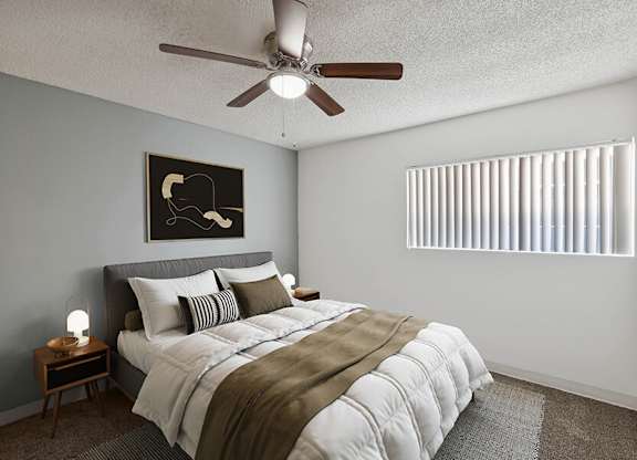 3-Bedroom Affordable Apartments in East Tucson, AZ - Lakeside Casitas - A Bedroom With A Neatly Made Bed, Bedside Tables, Ceiling Fan, Framed Wall Art, And A Window.