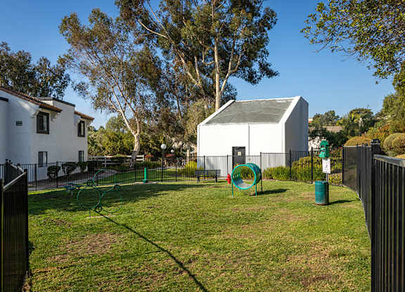 Community Dog Park with Agility Equipment at Santa Fe Ranch Apartments located in Carlsbad, CA.