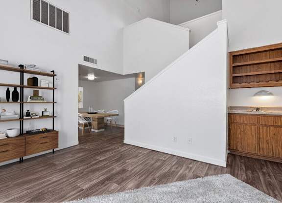Model Living Room with Wood-Style Flooring at District at Fiesta Park Apartments located in Mesa, AZ.