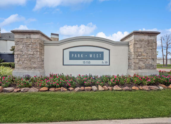 Monument Sign and Front Entrance at Park West Apartments located in Houston, TX.