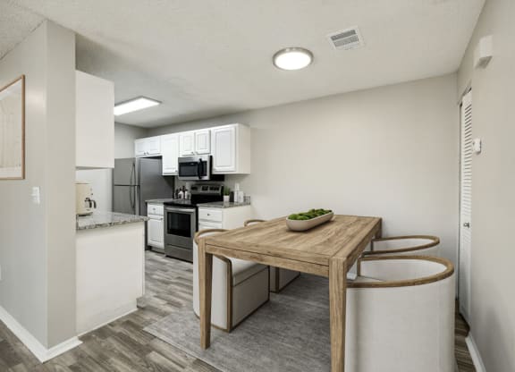 Model kitchen with a wooden table and two stools