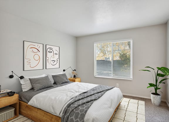 Model Bedroom with Carpet and Window View at Broadmoor Village Apartments in Salt Lake City, UT.