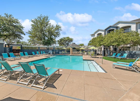 Community Swimming Pool with Pool Furniture at Allure North Dallas Apartments in Dallas, TX.